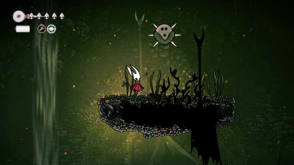 Hornet em pé sob uma caça em uma área de caverna musgosa em Hollow Knight Silksong.