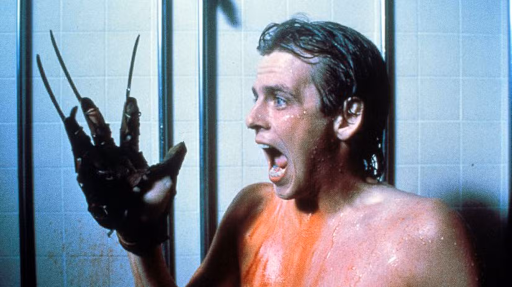 Jesse Walsh (Mark Patton) gritando, usando a luva de Freddy em A Nightmare on Elm Street 2: Freddy's Revenge
