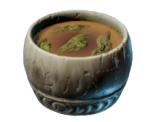 Herbal Mountain Tea em Enshrouded, mostrando uma xícara de madeira com folhas verdes no chá.
