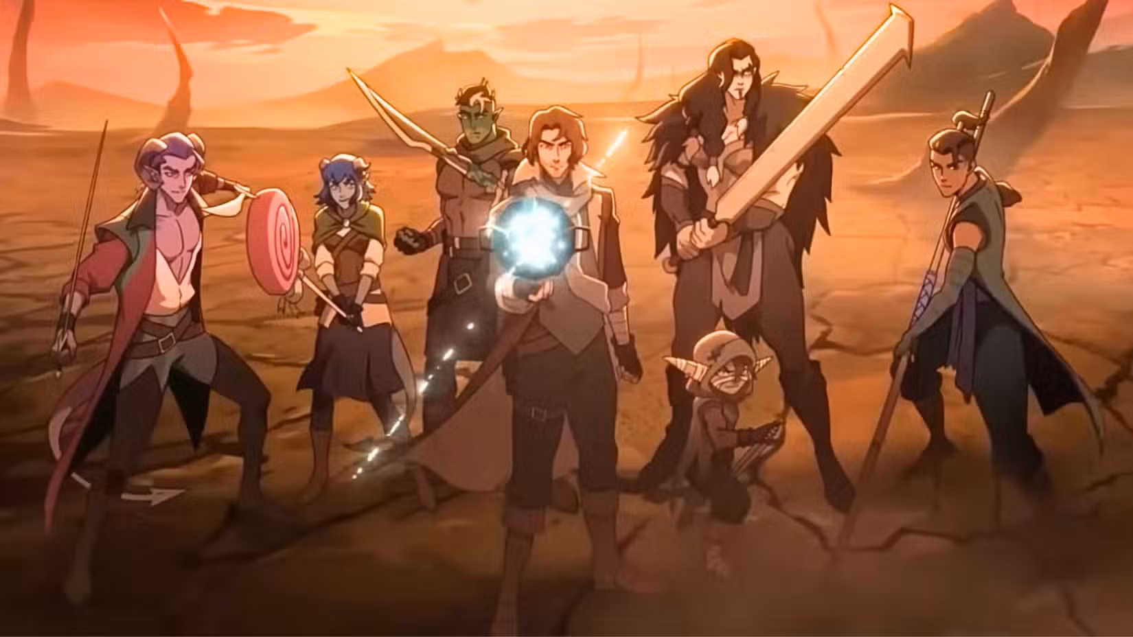 Uma captura de tela de The Mighty Nein, do Prime Video. Apresenta uma foto de grupo de The Mighty Nein, um grupo de aventureiros ambientado na fantástica terra de Exandria. Da esquerda para a direita está Mollymauk, um tiefling com chifres e um florete, Jester, um tiefling azul com um pirulito como arma, Fjord, um orc, Caleb, um mago humano, Nott, um goblin com punhais, Yasha, um Aasimar com uma espada enorme, e Beau, um monge.