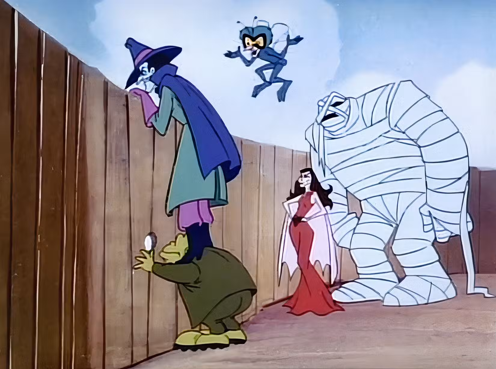 Os membros do OGRE - o humano de pele azul Dr. Dred, o sapo parecido com um sapo, o corpulento Mummy Man, a Fly de olhos esbugalhados e o Vampira estilo Morticia - ficam perto de uma cerca de madeira, espiando por cima dela ou através de nós, em Drak Pack