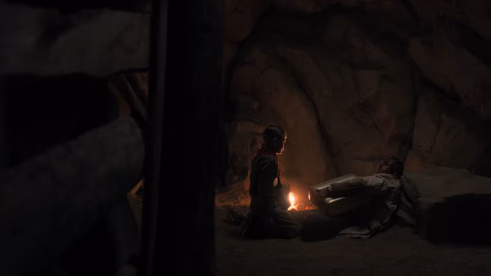 Um jovem Henry Creel (Maksim Blatt) se ajoelha na frente de um homem morto segurando uma pasta em um poço de mina em Nevada em Stranger Things, temporada 5, episódio 6