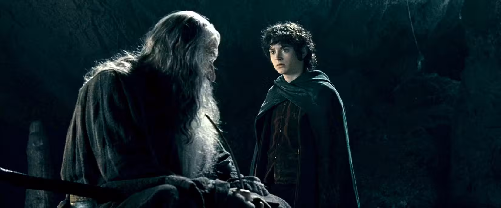 Frodo e Gandalf falam sobre quantos que viveram para ver esses tempos gostariam de não ter feito parte da Sociedade do Anel.