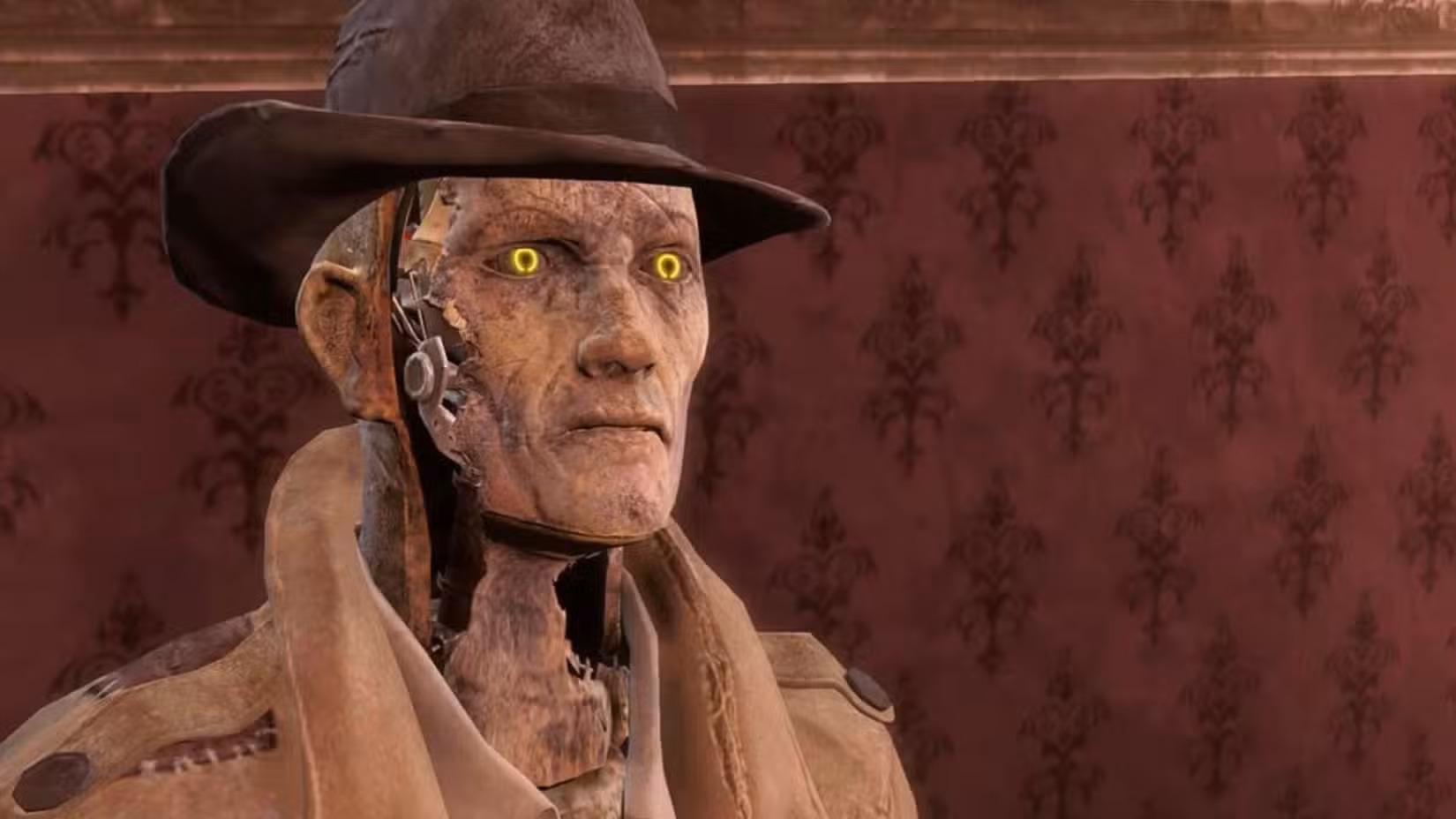 Uma imagem do Fallout 4 da Bethesda. Ela mostra Nick Valentine, um sintetizador (um robô) com pele descascada que usa um espanador marrom e um chapéu.
