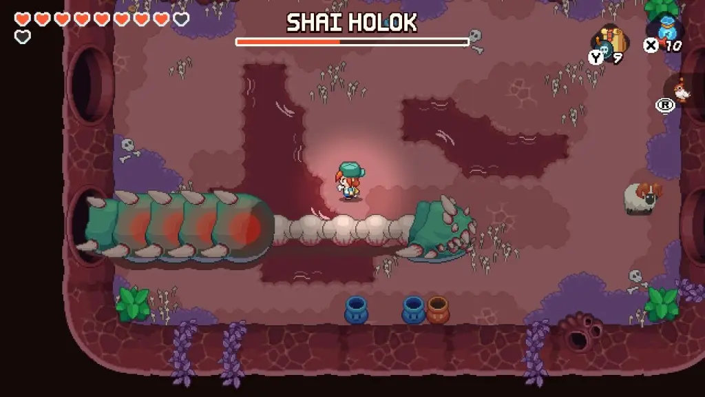 Nia está acima de um verme gigante chamado Shai Holok, que está sem metade do corpo.