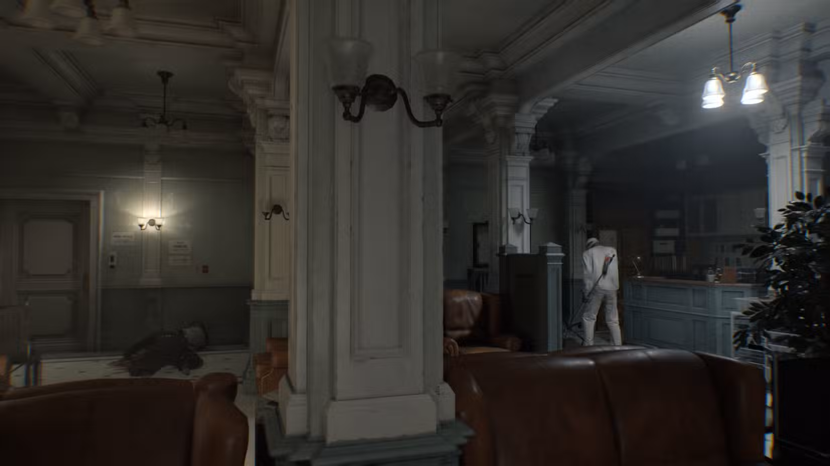 Dois zumbis na sala de espera da ala leste em Resident Evil Requiem