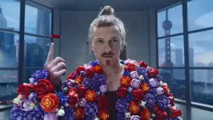 Tom Holland wearing the flowers from Midsommar in a LEGO commercial