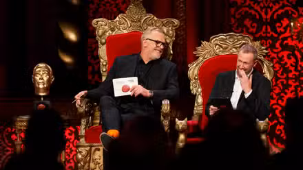 Greg Davies and Alex Horne share a laugh in their comically-sized throne chairs next to a golden statue of Davies’ head on the set of Taskmaster.
