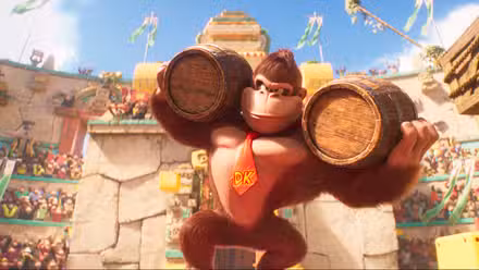 Donkey Kong carries two big barrels on his shoulders in a stadium full of apes in The Super Mario Bros. Movie