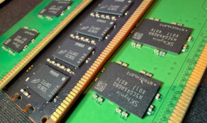 A close-up photo of a pair of Micron and SK Hynix DDR5 DIMMs, showing the memory modules on black/green PCBs