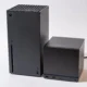 An Xbox Series X next to a Steam Machine. The Steam Machine is roughly half the size of the Series X.