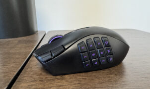 The Razer Naga V3 Pro on a wooden table from the left hand side, showing the 12 button faceplate