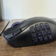 The Razer Naga V3 Pro on a wooden table from the left hand side, showing the 12 button faceplate