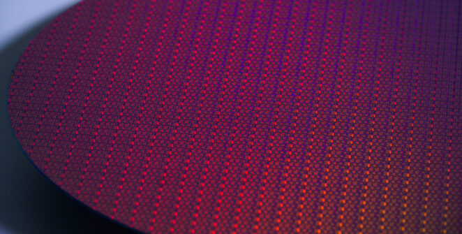 A close-up stylized photo of a silicon wafer, showing many small processor dies
